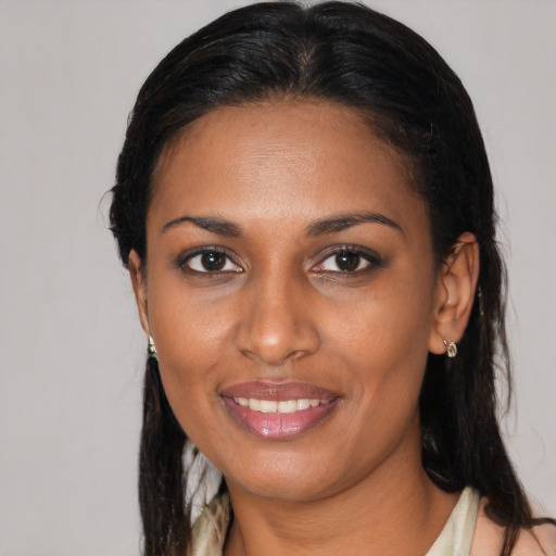 Joyful black young-adult female with medium  brown hair and brown eyes