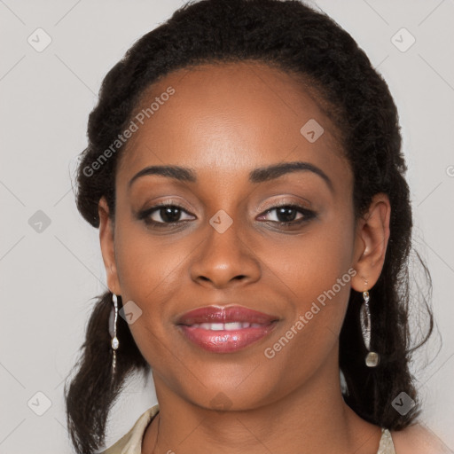 Joyful black young-adult female with long  black hair and brown eyes