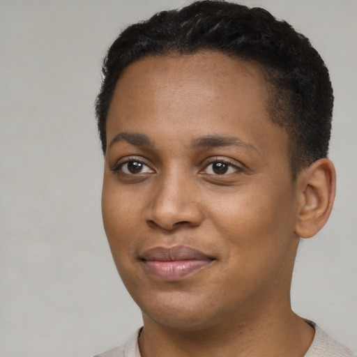 Joyful black young-adult female with short  brown hair and brown eyes