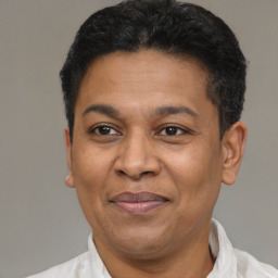 Joyful latino adult male with short  black hair and brown eyes