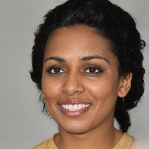 Joyful latino young-adult female with medium  black hair and brown eyes