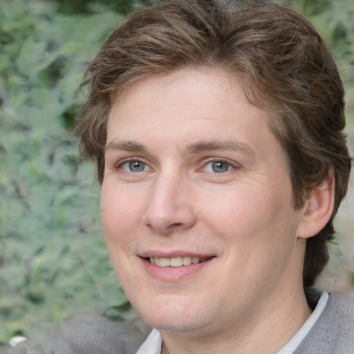 Joyful white adult female with medium  brown hair and green eyes