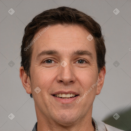 Joyful white adult male with short  brown hair and grey eyes