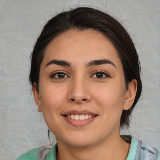 Joyful white young-adult female with medium  brown hair and brown eyes