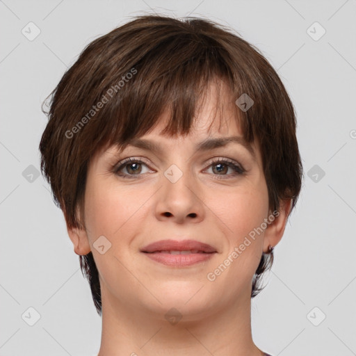 Joyful white young-adult female with short  brown hair and grey eyes