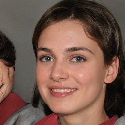 Joyful white young-adult female with medium  brown hair and blue eyes