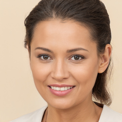 Joyful white young-adult female with medium  brown hair and brown eyes