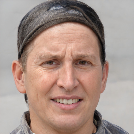 Joyful white adult male with short  brown hair and grey eyes