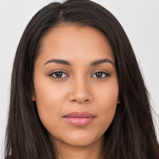 Joyful latino young-adult female with long  brown hair and brown eyes