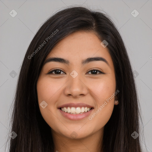 Joyful latino young-adult female with long  brown hair and brown eyes