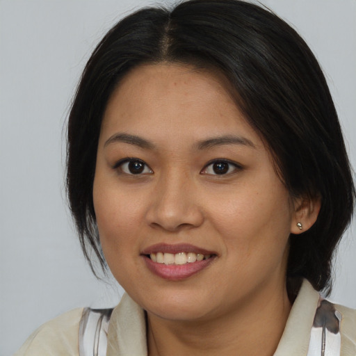 Joyful asian young-adult female with medium  brown hair and brown eyes