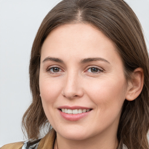 Joyful white young-adult female with long  brown hair and grey eyes