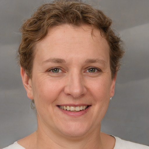 Joyful white adult female with short  brown hair and grey eyes