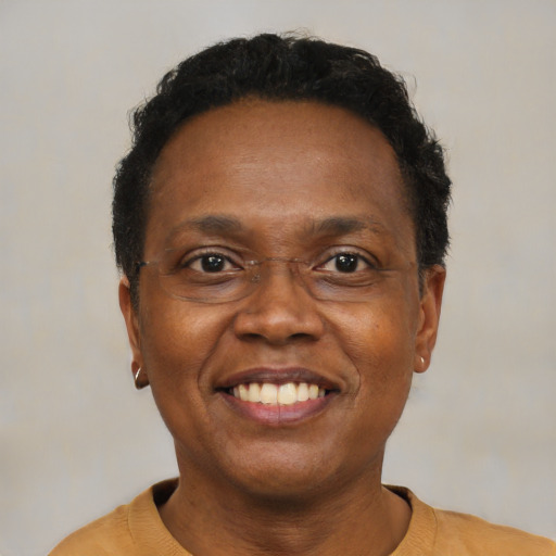 Joyful black adult male with short  black hair and brown eyes