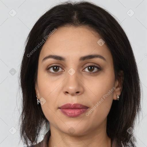 Joyful latino young-adult female with medium  brown hair and brown eyes