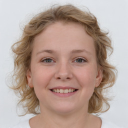 Joyful white child female with medium  brown hair and blue eyes