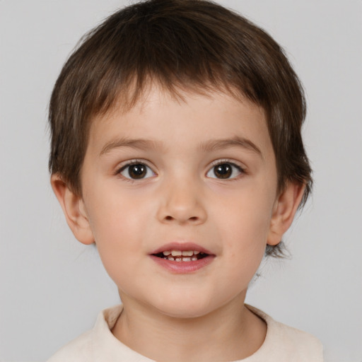 Joyful white child male with short  brown hair and brown eyes