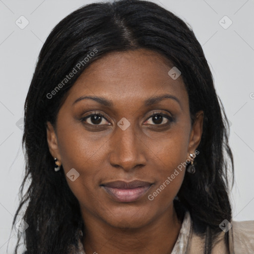 Joyful black adult female with long  brown hair and brown eyes