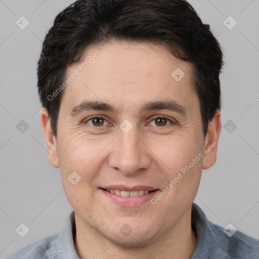 Joyful white adult male with short  brown hair and brown eyes