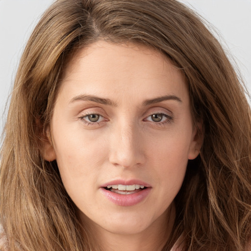 Joyful white young-adult female with long  brown hair and green eyes