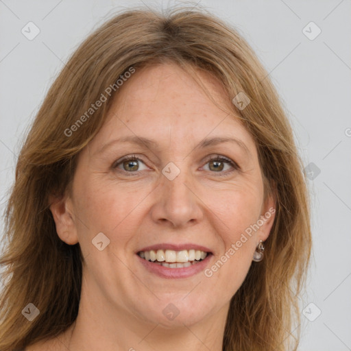 Joyful white adult female with long  brown hair and brown eyes