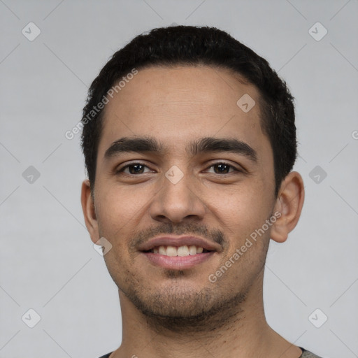 Joyful latino young-adult male with short  black hair and brown eyes