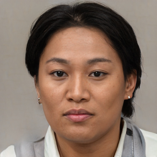 Neutral asian adult female with medium  brown hair and brown eyes