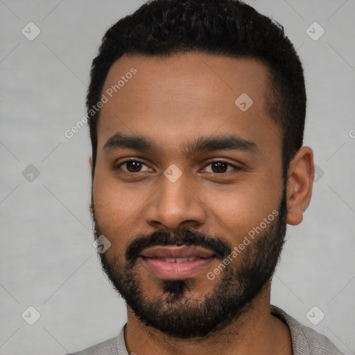 Joyful black young-adult male with short  black hair and brown eyes