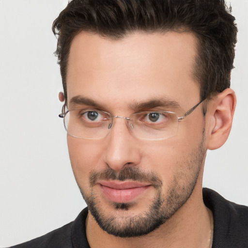 Joyful white adult male with short  brown hair and brown eyes