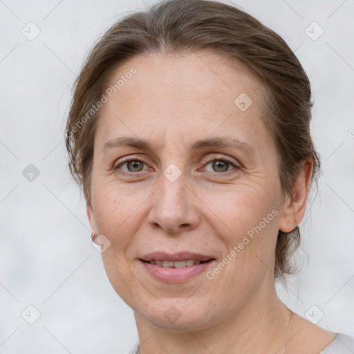 Joyful white adult female with medium  brown hair and grey eyes