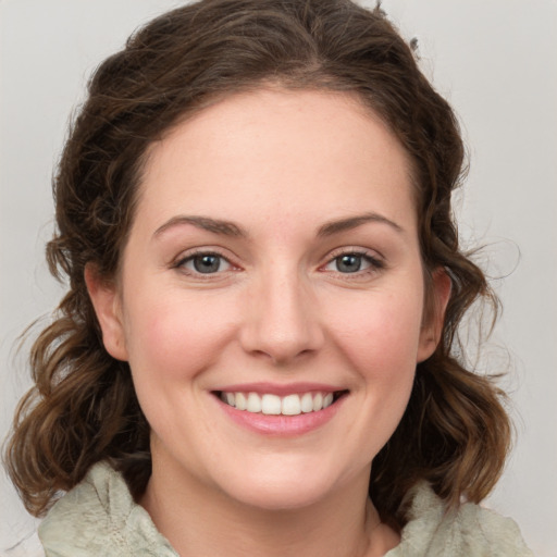 Joyful white young-adult female with medium  brown hair and green eyes