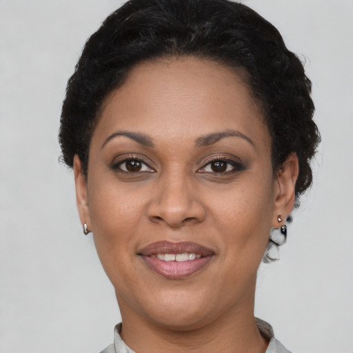 Joyful latino adult female with short  brown hair and brown eyes