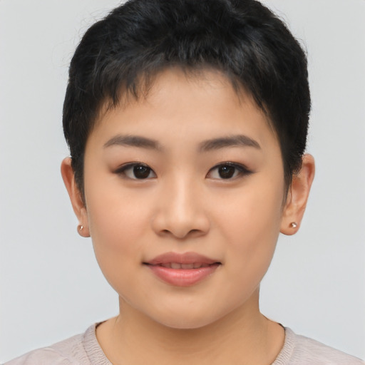 Joyful asian child female with short  brown hair and brown eyes