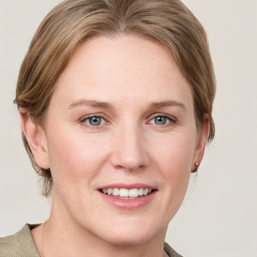 Joyful white young-adult female with medium  brown hair and blue eyes