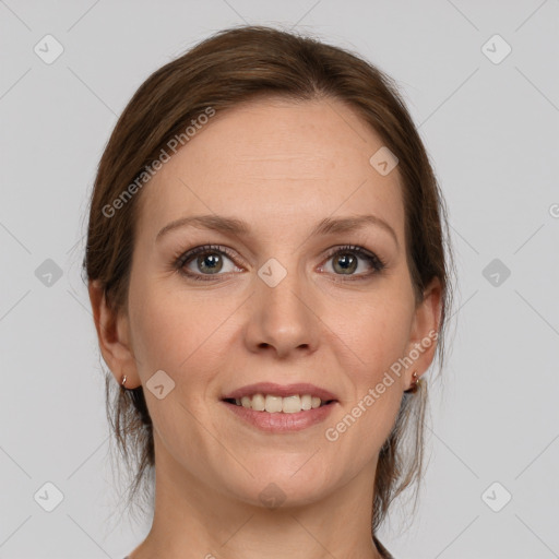 Joyful white adult female with medium  brown hair and grey eyes