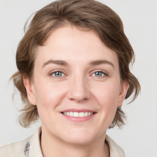 Joyful white young-adult female with medium  brown hair and blue eyes