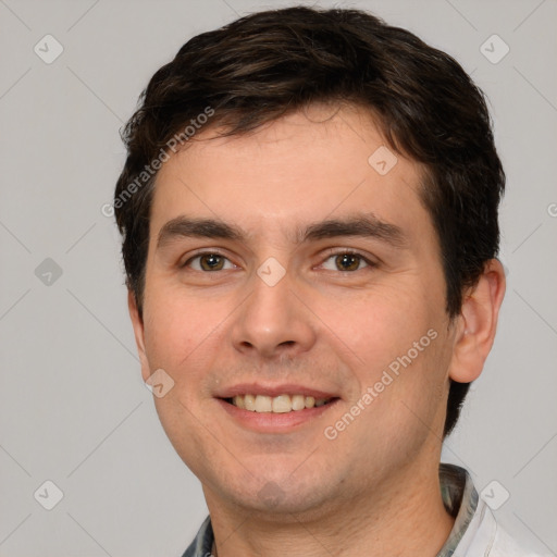 Joyful white young-adult male with short  brown hair and brown eyes