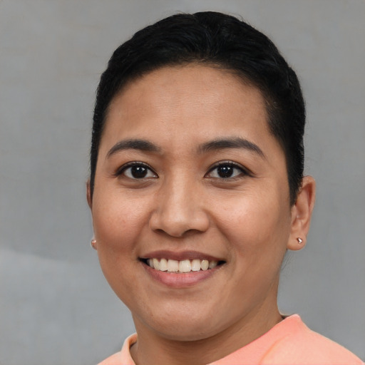 Joyful asian young-adult female with short  brown hair and brown eyes