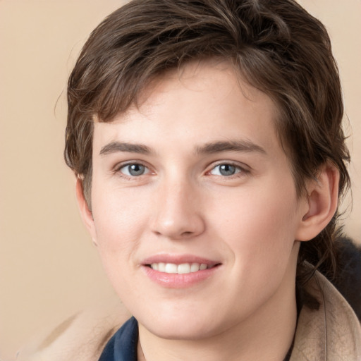 Joyful white young-adult male with medium  brown hair and grey eyes