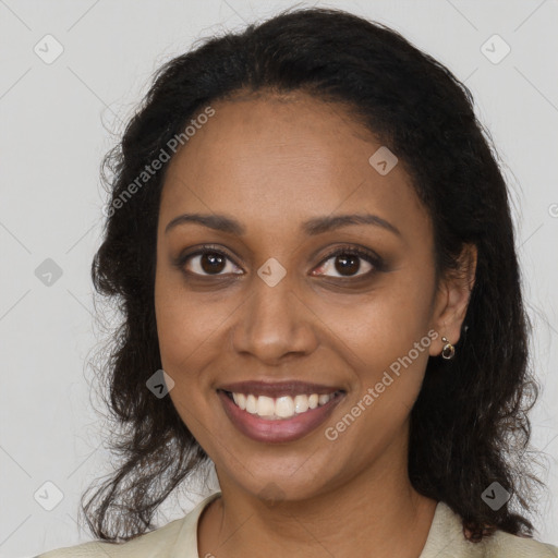 Joyful black young-adult female with long  brown hair and brown eyes