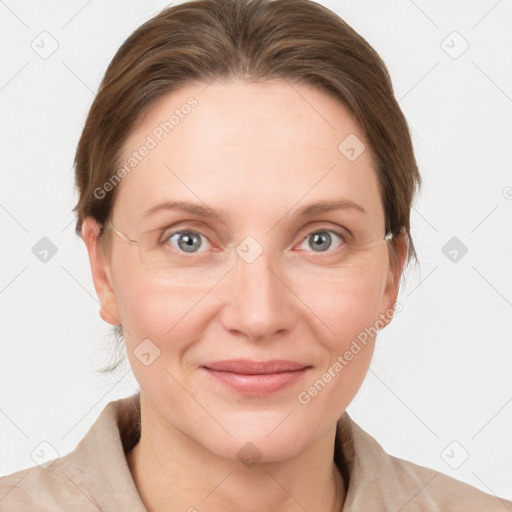 Joyful white adult female with medium  brown hair and grey eyes