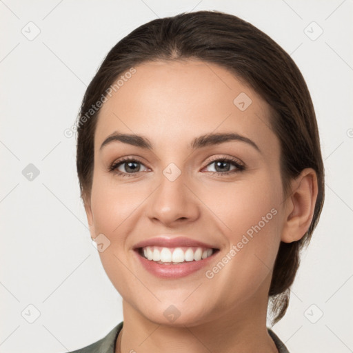 Joyful white young-adult female with medium  brown hair and grey eyes