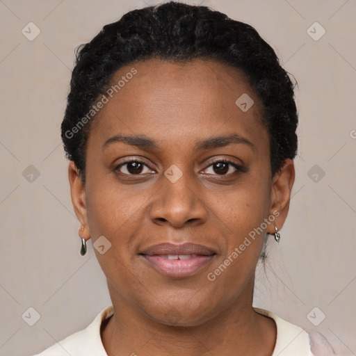 Joyful black young-adult female with short  black hair and brown eyes