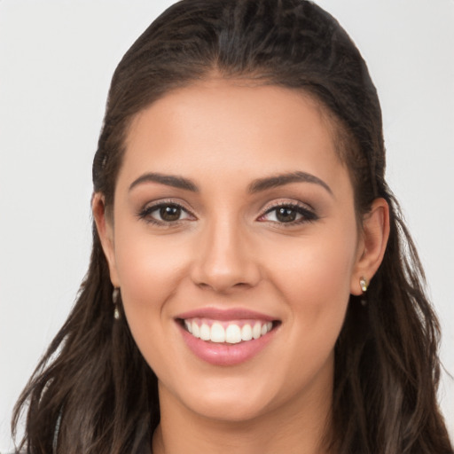 Joyful white young-adult female with long  brown hair and brown eyes