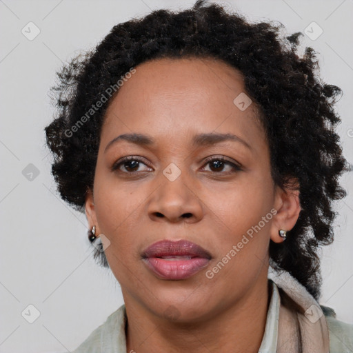 Joyful black adult female with short  brown hair and brown eyes