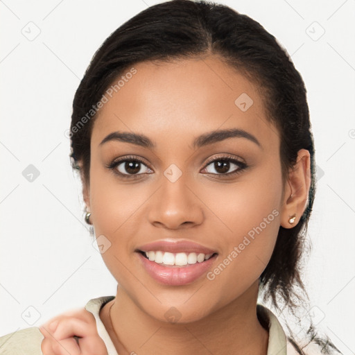 Joyful latino young-adult female with long  brown hair and brown eyes