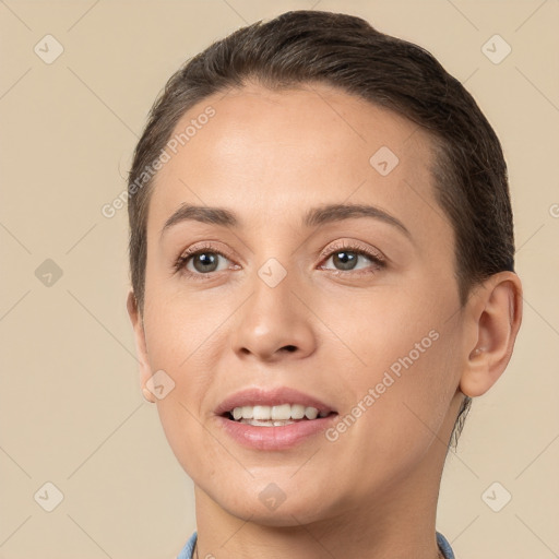 Joyful white young-adult female with short  brown hair and brown eyes