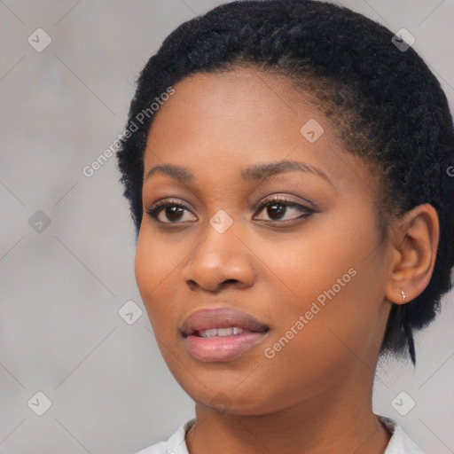 Joyful black young-adult female with short  black hair and brown eyes