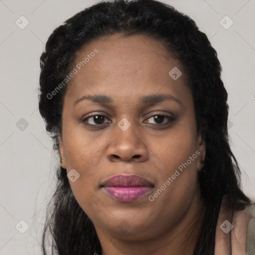 Joyful black adult female with long  black hair and brown eyes