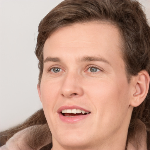 Joyful white young-adult male with medium  brown hair and grey eyes